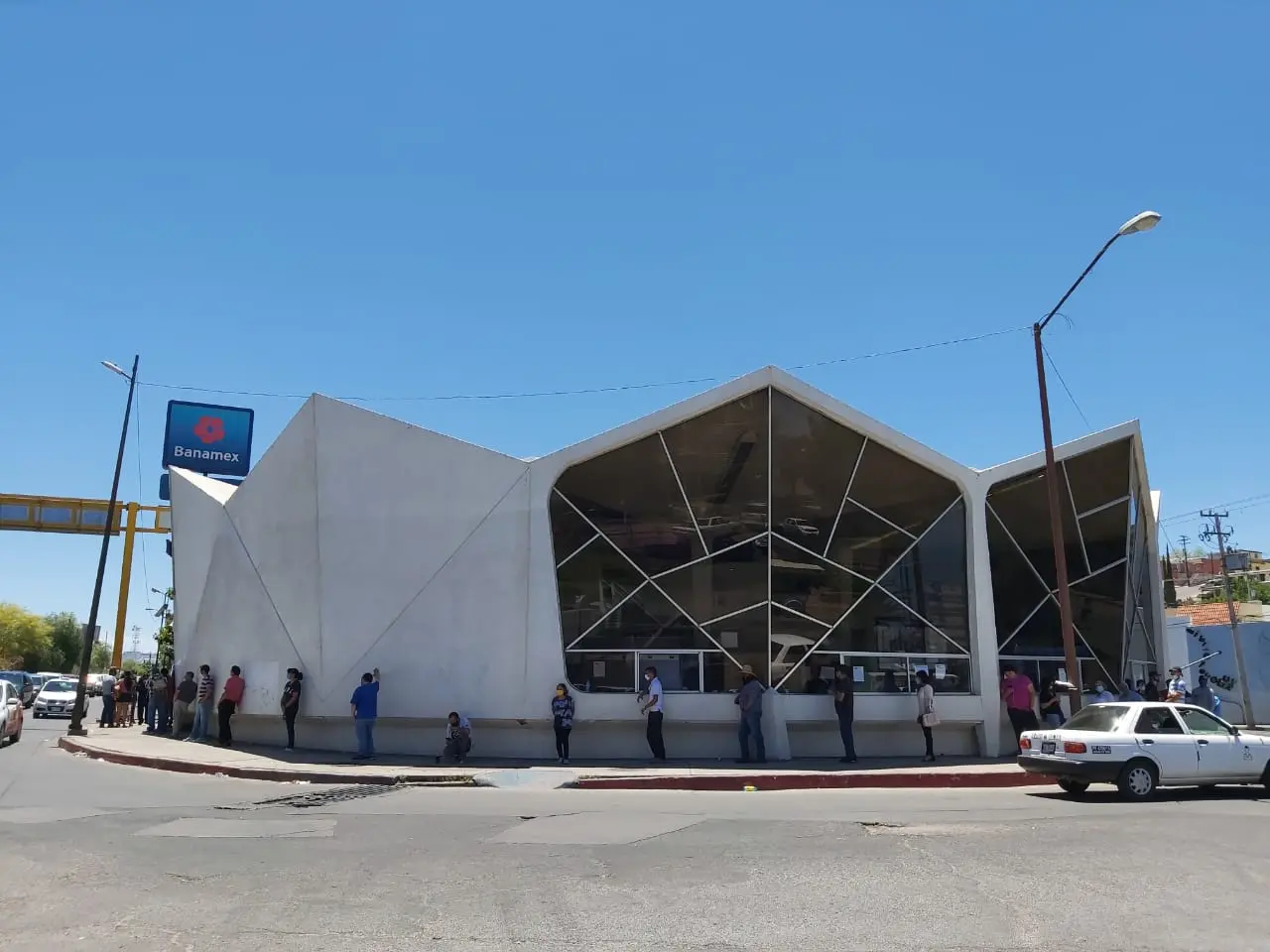 Personas mayores hacen fila bajo los fuertes rayos del Sol en Nogales